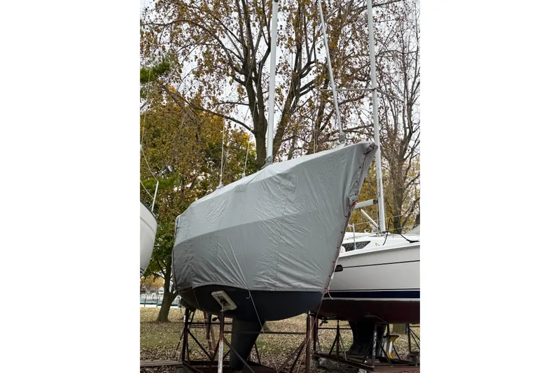 Slide: The Image of Covered 1993 Catalina 28 sailboat on stands, surrounded by autumn trees. - 2