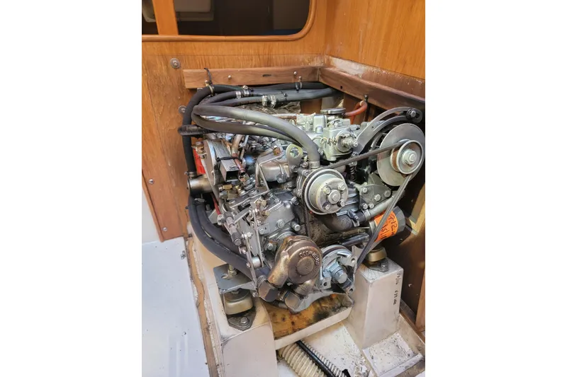 Slide: The Image of Engine of a 1993 Catalina 28 sailboat, showcasing mechanical components and hoses. - 30