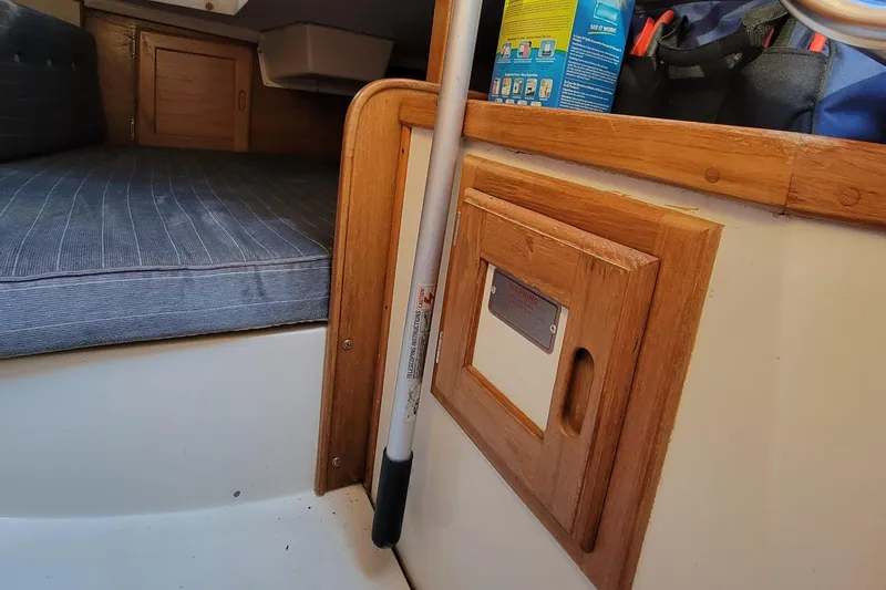 Slide: The Image of Interior of a 1993 Catalina 28 sailboat with wooden cabinetry and striped cushion. - 19