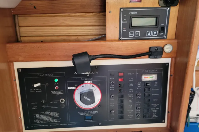 Slide: The Image of Electrical control panel of a 1993 Catalina 28 yacht, featuring various switches and gauges. - 15