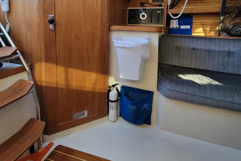 Slide: The Image of Interior of a 1993 Catalina 28 sailboat with wooden stairs and seating area. - 21