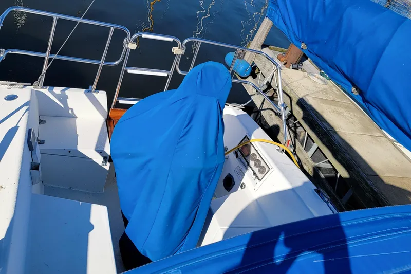 Slide: The Image of 1993 Catalina 28 sailboat cockpit with blue covers, docked at a marina. - 8