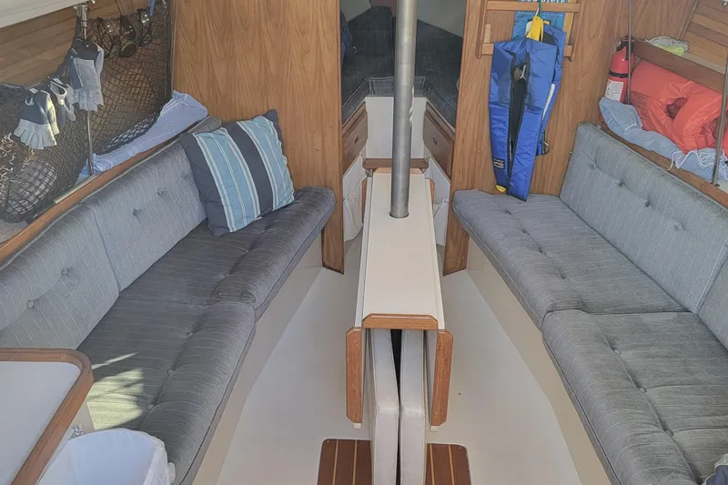 Slide: The Image of Interior of a 1993 Catalina 28 sailboat with cozy seating and nautical decor. - 12
