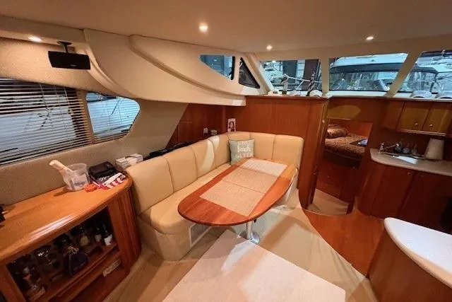 Slide: The Image of Interior of 2003 Silverton 39 Motor Yacht with cozy seating and dining area. - 3