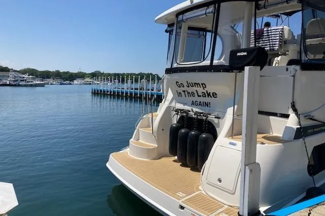 Slide: The Image of 2003 Silverton 39 Motor Yacht docked with humorous "Go Jump In The Lake Again!" sign. - 6