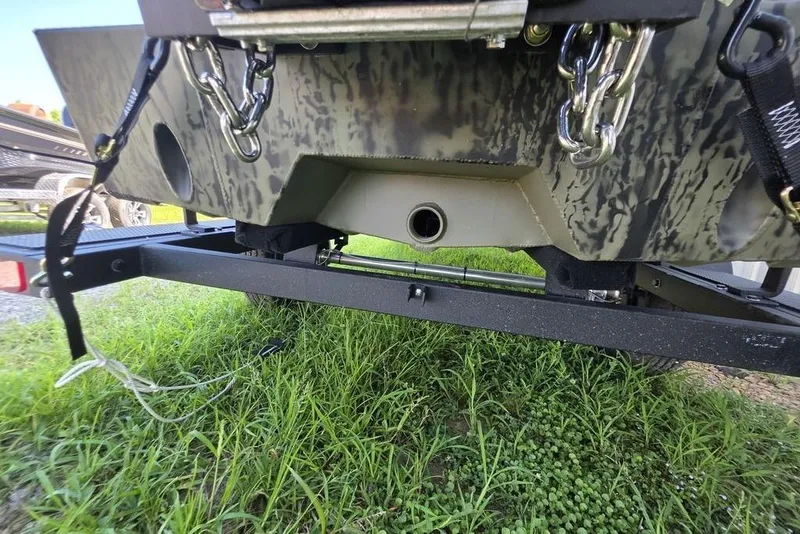 Slide: The Image of 2026 Tracker Grizzly 1650 T Prairie Wings Edition boat on trailer, grassy background. - 11