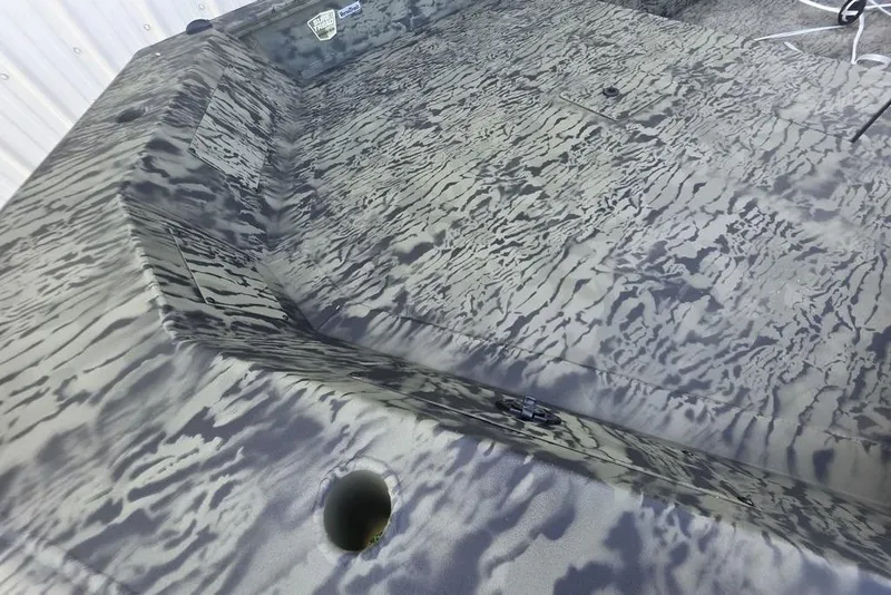 Slide: The Image of 2026 Tracker Grizzly 1650 T Prairie Wings Edition boat with camouflage interior design. - 13