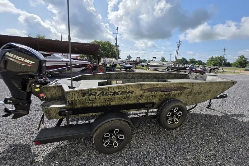 Slide: The Image of 2026 Tracker Grizzly 1650 T Prairie Wings Edition boat on trailer, outdoor display. - 14