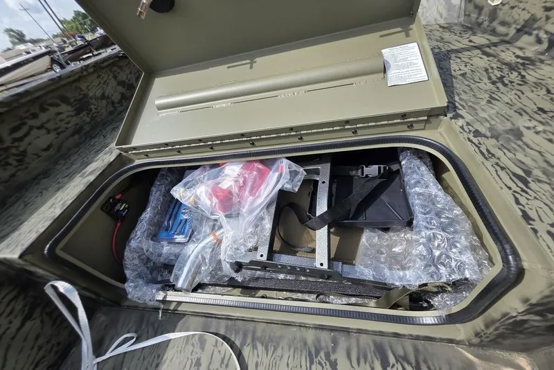 Slide: The Image of Open storage compartment in 2026 Tracker Grizzly 1650 T Prairie Wings Edition boat. - 15