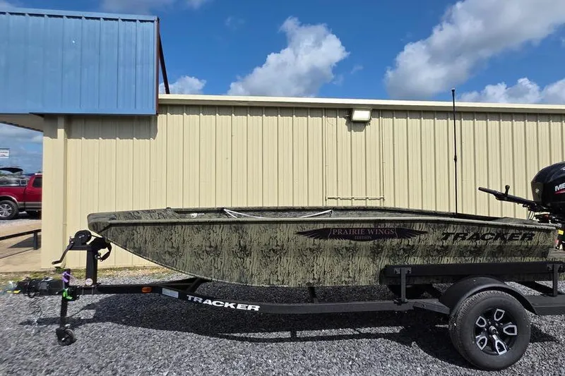 Slide: The Image of 2026 Tracker Grizzly 1650 T Prairie Wings Edition boat on trailer, parked outdoors. - 3
