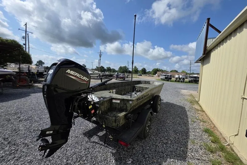 Slide: The Image of 2026 Tracker Grizzly 1650 T Prairie Wings Edition boat with Mercury engine on gravel lot. - 7