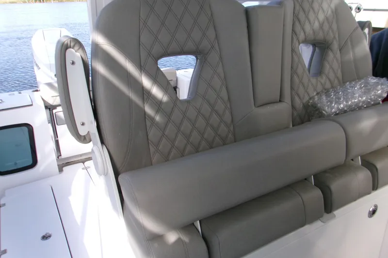 Slide: The Image of 2025 Sportsman Open 322 Center Console boat seats with diamond stitching detail. - 25