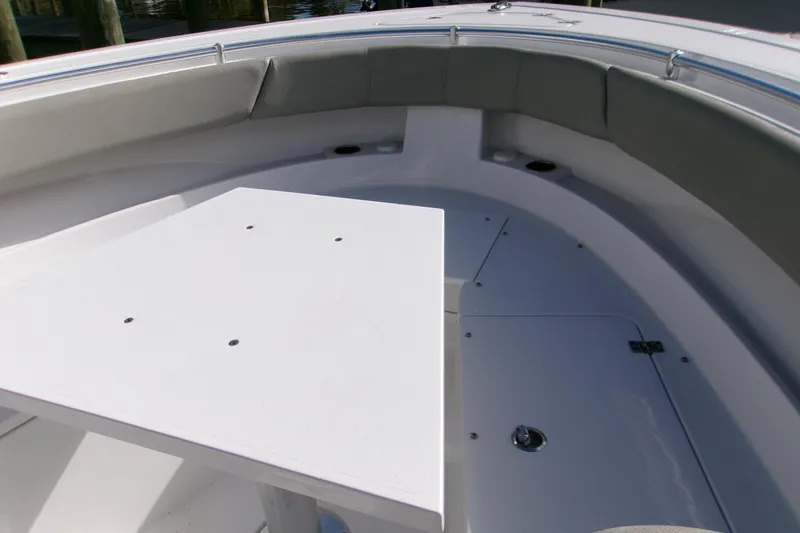 Slide: The Image of 2025 Sportsman Open 322 Center Console boat interior with seating and table. - 26