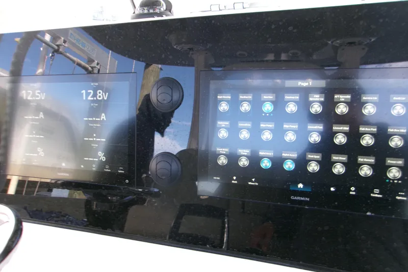 Slide: The Image of Dashboard of 2025 Sportsman Open 322 Center Console with Garmin displays and controls. - 3