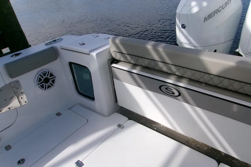 Slide: The Image of 2025 Sportsman Open 322 Center Console boat interior with seating and Mercury engines. - 30
