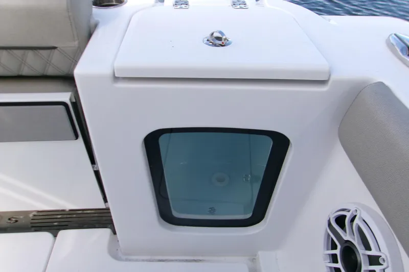 Slide: The Image of 2025 Sportsman Open 322 Center Console boat detail with storage compartment and speaker. - 4