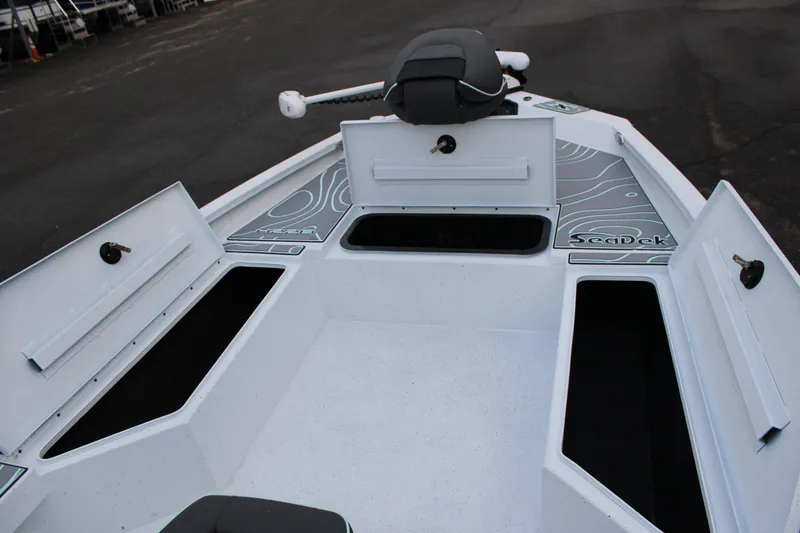 Slide: The Image of 2026 Xpress H22B Bay boat interior with open storage compartments and SeaDek flooring. - 12