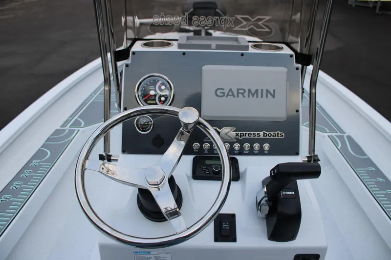 Slide: The Image of 2026 Xpress H22B Bay boat dashboard with Garmin display and Yamaha controls. - 4
