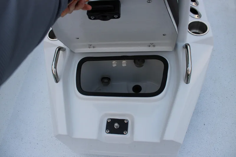 Slide: The Image of Open storage compartment on 2026 Xpress H22B Bay boat with stainless steel handles. - 6