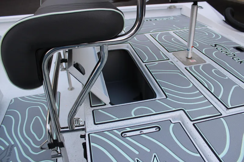 Slide: The Image of 2026 Xpress H22B Bay boat interior with SeaDek flooring and storage compartments. - 9