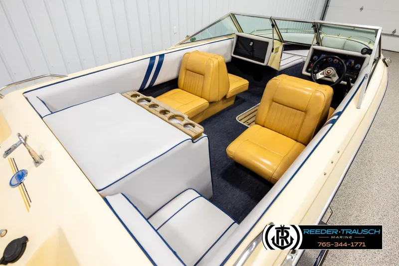 Slide: The Image of 1988 Celebrity 180 V boat interior with yellow seats and blue accents. - 10