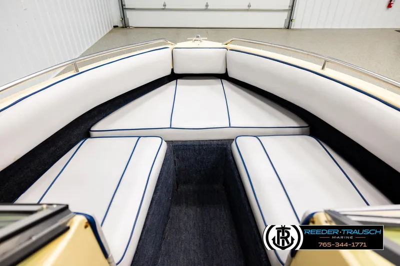 Slide: The Image of Interior of 1988 Celebrity 180 V boat with white and blue seating. - 13
