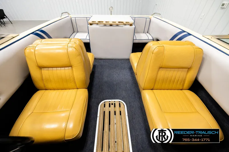 Slide: The Image of 1988 Celebrity 180 V boat interior with yellow seats and blue accents. - 15