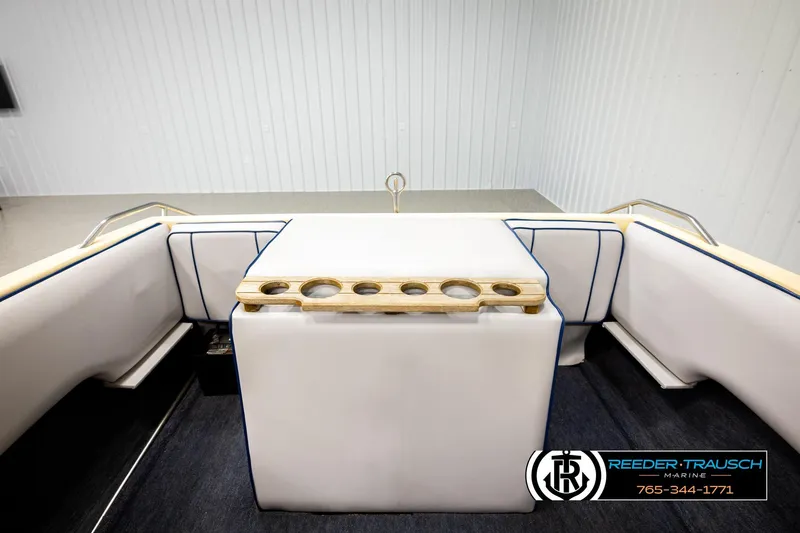 Slide: The Image of 1988 Celebrity 180 V boat interior with white seating and cup holders. - 17