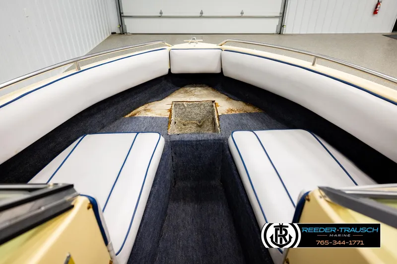 Slide: The Image of Interior of a 1988 Celebrity 180 V boat with white seating and blue trim. - 22