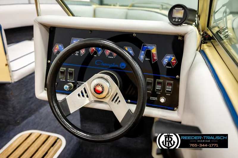 Slide: The Image of 1988 Celebrity 180 V boat dashboard with steering wheel and control panel. - 24