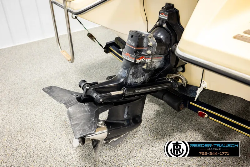 Slide: The Image of 1988 Celebrity 180 V boat with MerCruiser outboard motor, displayed on showroom floor. - 35