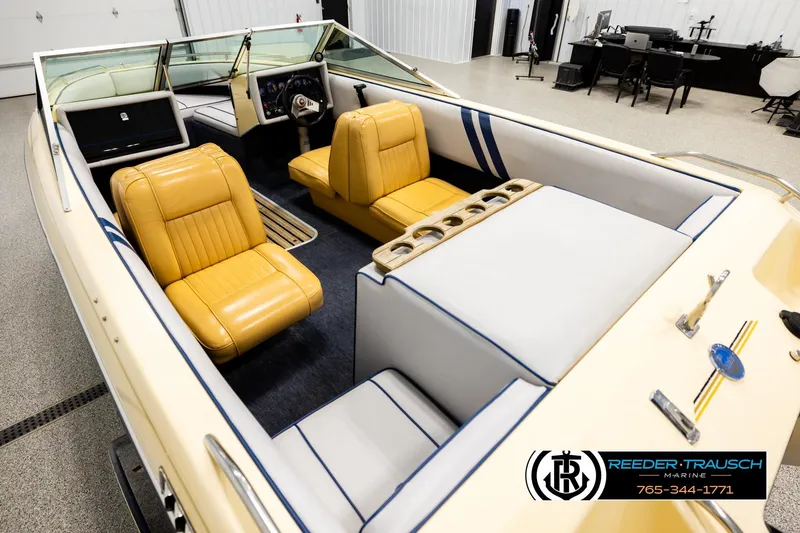Slide: The Image of 1988 Celebrity 180 V boat interior with yellow seats, showcased by Reeder-Trausch Marine. - 9