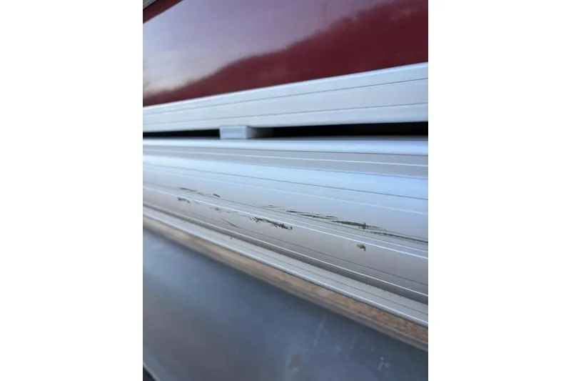 Slide: The Image of 2023 Sun Tracker Party Barge 22 DLX with visible scratches on the side panel. - 16