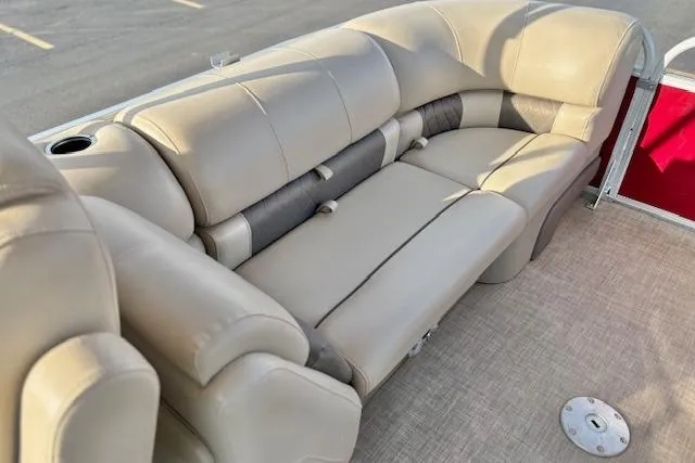 Slide: The Image of 2023 Sun Tracker Party Barge 22 DLX, featuring spacious beige seating and cup holder. - 18