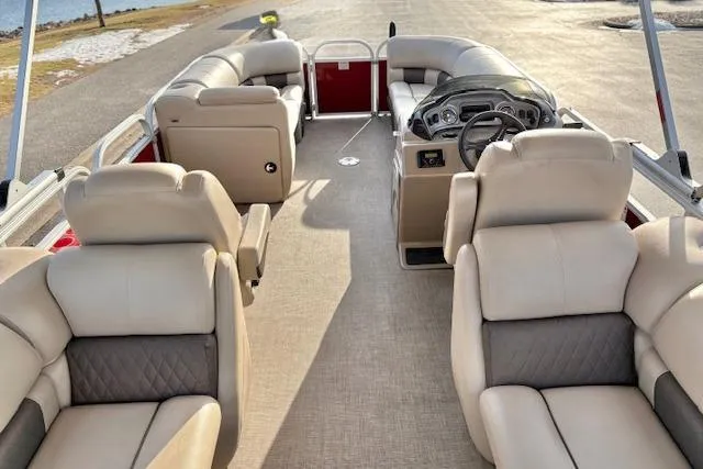 Slide: The Image of 2023 Sun Tracker Party Barge 22 DLX interior with plush seating and modern dashboard. - 20