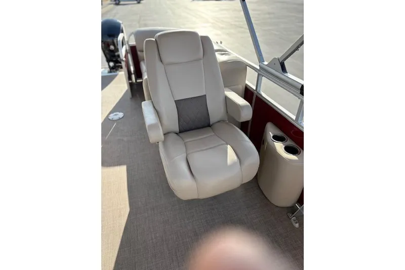 Slide: The Image of 2023 Sun Tracker Party Barge 22 DLX captain's chair with armrests and cup holders. - 23