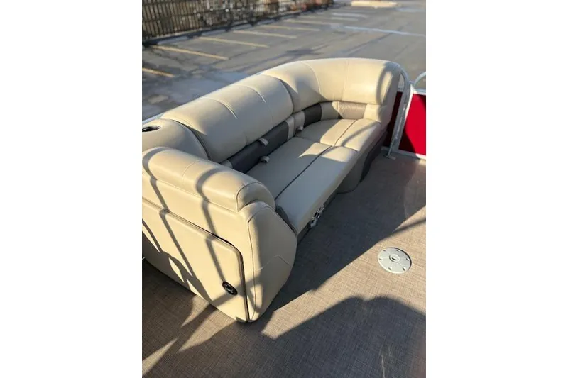 Slide: The Image of 2023 Sun Tracker Party Barge 22 DLX, beige seating, outdoor setting. - 26