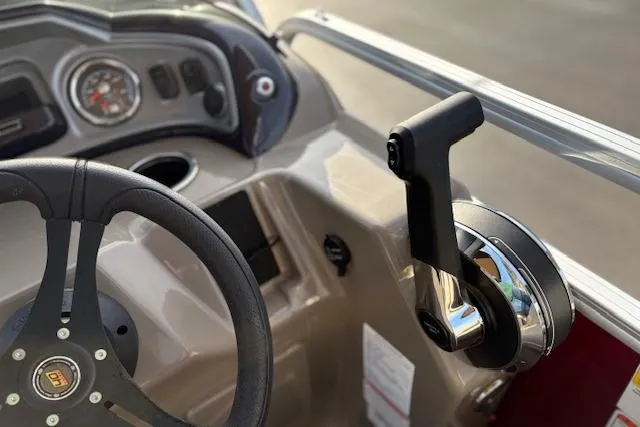 Slide: The Image of 2023 Sun Tracker Party Barge 22 DLX steering wheel and throttle control close-up. - 31