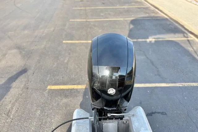 Slide: The Image of 2023 Sun Tracker Party Barge 22 DLX outboard motor in a parking lot. - 46