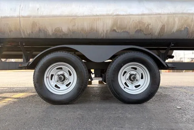Slide: The Image of 2023 Sun Tracker Party Barge 22 DLX trailer wheels on pavement. - 49