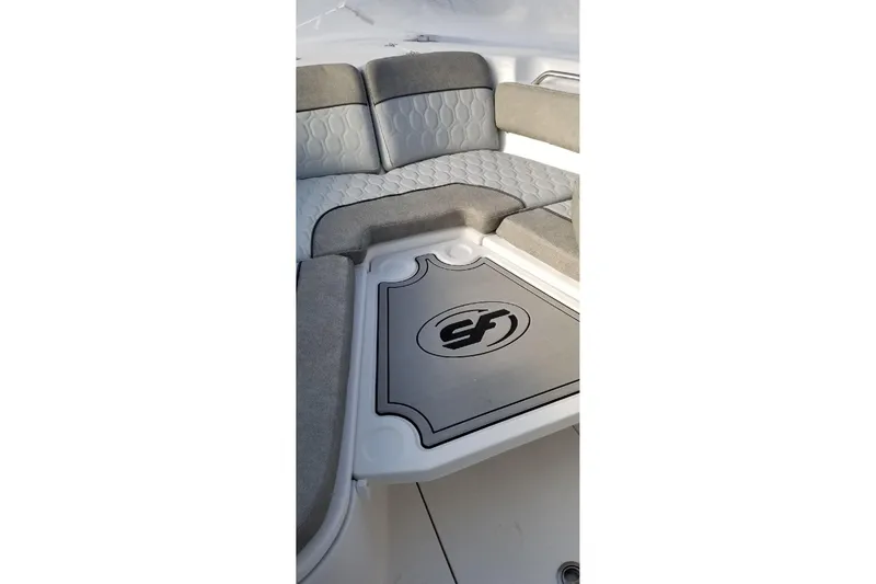 Slide: The Image of 2022 Sea Fox 248 Commander boat interior with cushioned seating and logo detail. - 10