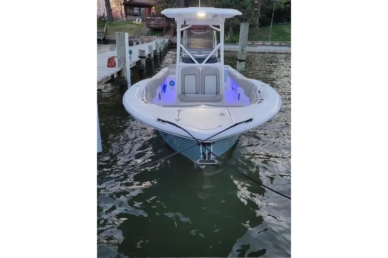 Slide: The Image of 2022 Sea Fox 248 Commander boat docked, illuminated interior, calm water setting. - 16