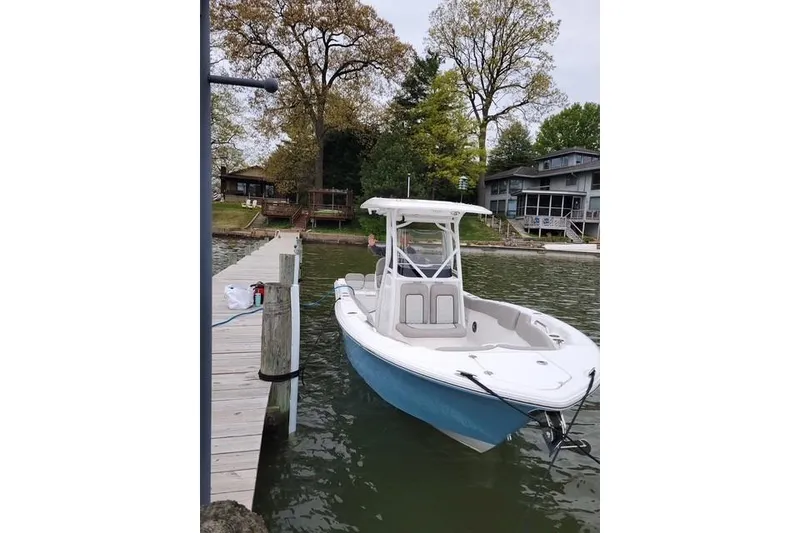 Slide: The Image of 2022 Sea Fox 248 Commander boat docked by a lakeside pier. - 5