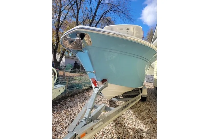 Slide: The Image of 2022 Sea Fox 248 Commander boat on trailer, parked outdoors under blue sky. - 6