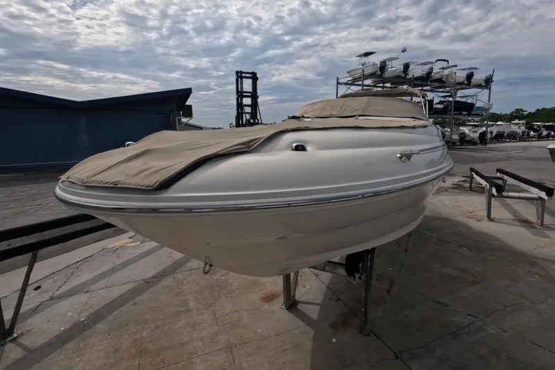Slide: The Image of 2001 Sea Ray 240 Sundeck boat on dry dock, covered and ready for maintenance. - 10