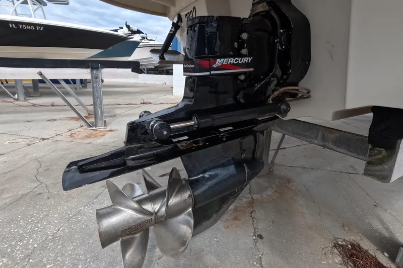 Slide: The Image of 2001 Sea Ray 240 Sundeck with Mercury outboard motor, docked on concrete surface. - 17