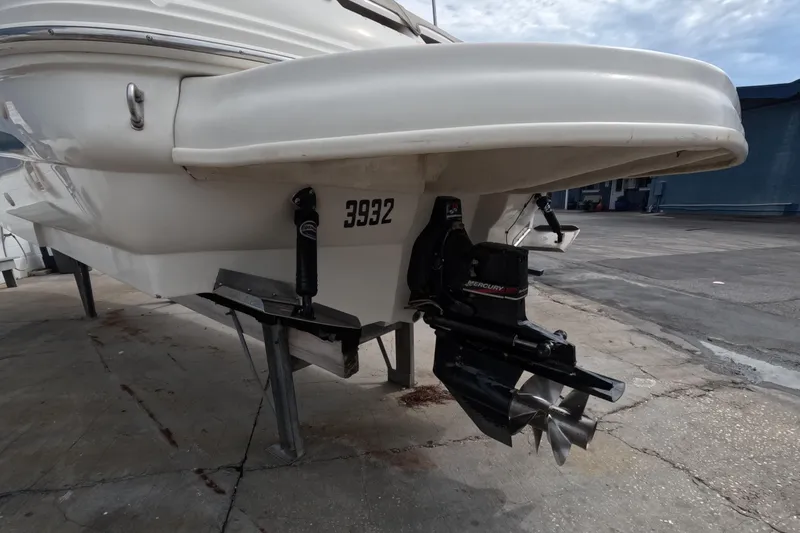 Slide: The Image of 2001 Sea Ray 240 Sundeck boat with Mercury outboard motor on a dock. - 19