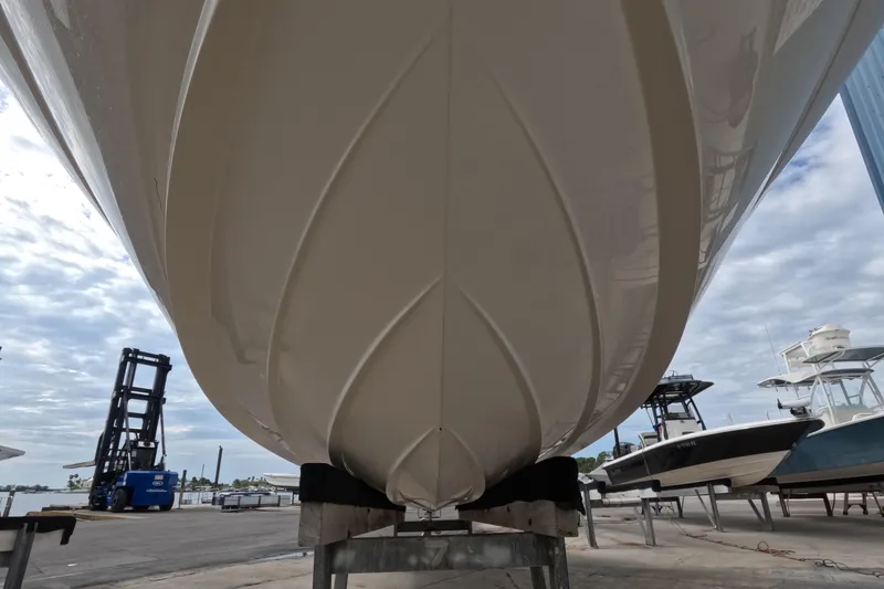 Slide: The Image of 2001 Sea Ray 240 Sundeck boat hull on dry dock, under cloudy sky. - 22