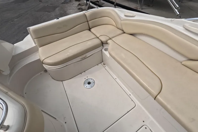 Slide: The Image of 2001 Sea Ray 240 Sundeck interior with beige seating and spacious layout. - 29