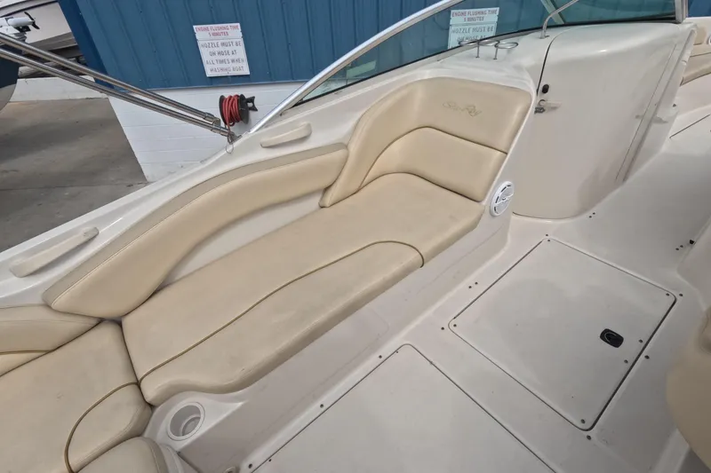 Slide: The Image of 2001 Sea Ray 240 Sundeck interior with beige seating and spacious deck layout. - 30